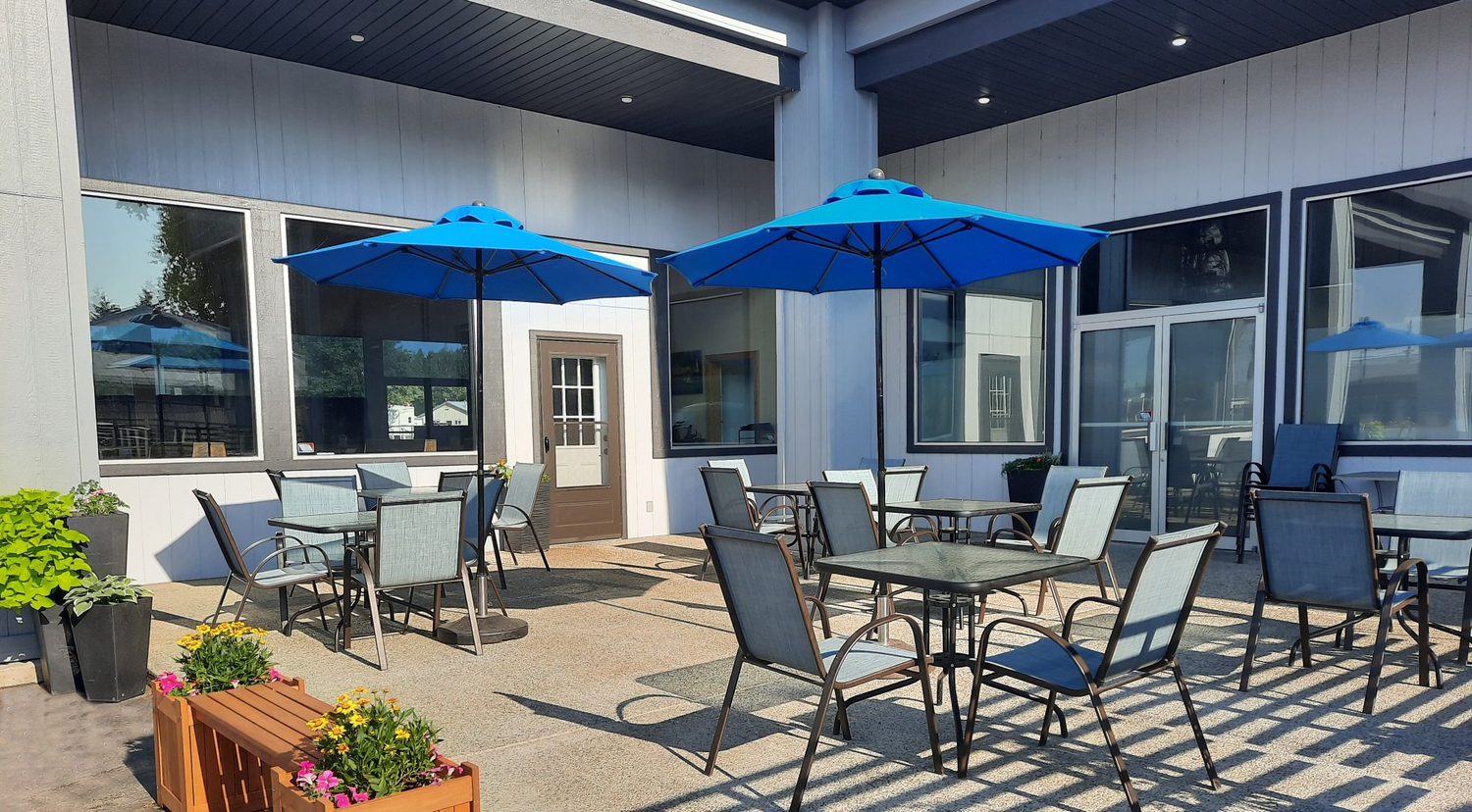 Cafe 95 outdoor patio with blue umbrellas and tables
